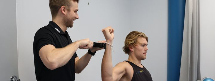 Coast Sport Physiotherapist performing treatment on a wrist injury