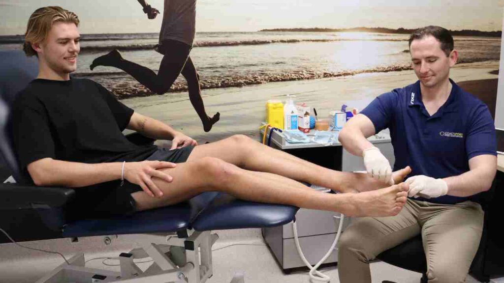 Man having foot sports therapy in a clinic